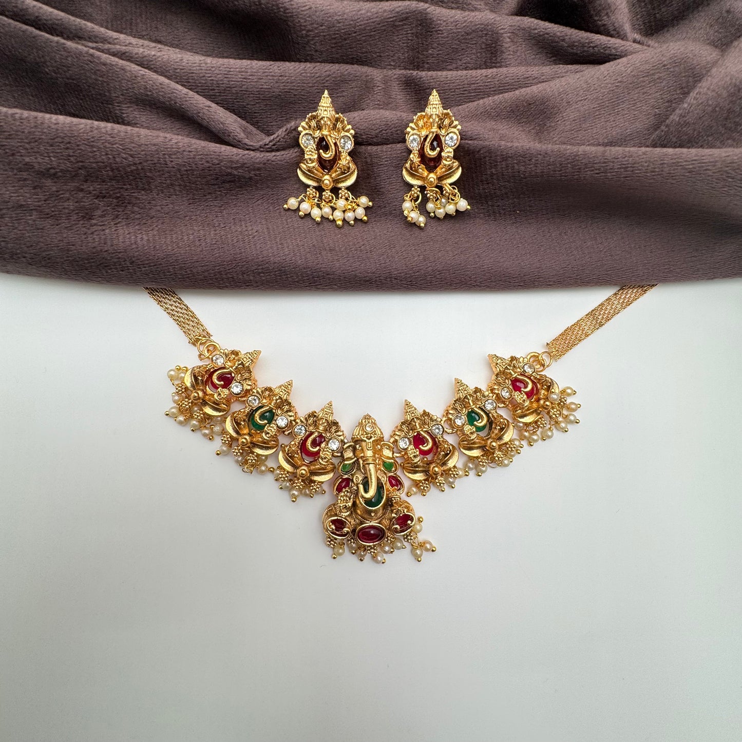 Antique Ganesha Nakshi Temple Choker Set – Ruby & Emerald Accents in Matte Gold Finish